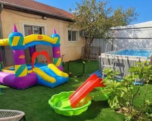 a backyard with a play set and a pool at Neoth Deshe 770 in Safed
