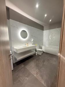 a bathroom with a sink and a tub and a toilet at Fatses in Nea Plagia +6 photos