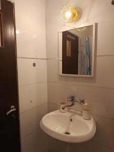 a white bathroom with a sink and a mirror at Neoth Deshe 770 in Safed +20 photos