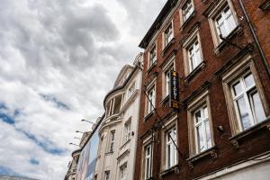 a brick building with a sign on the side of it at Apartamenty Młyńska15 self check-in 24h in Katowice