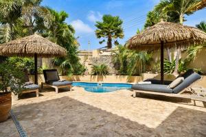 a resort with two chairs and a swimming pool at Bamboo Bonaire by Boutique Bonaire Unique Resorts in Kralendijk