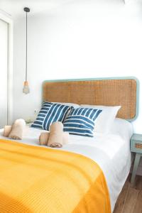 a bedroom with a large bed with blue and white pillows at Villa Martena in Cambados