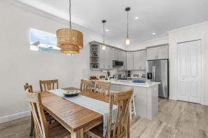 a kitchen and dining room with a wooden table and chairs at Lavender Life in Saint James City