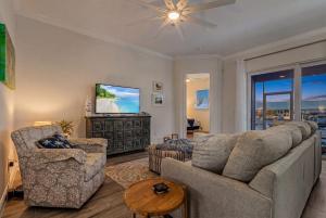 a living room with a couch and a tv at Lavender Life in Saint James City +40 photos