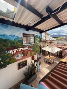 a mural on the wall of a building with stairs at Hospedaje El Encanto in Zipaquirá