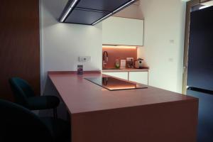 a kitchen with a counter and a chair in a room at Aurora Lucana in Matera