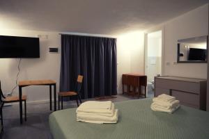 a hotel room with a bed with towels on it at Aurora Lucana in Matera