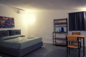 a bedroom with a bed and a table and a chair at Aurora Lucana in Matera