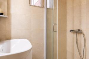 a bathroom with a shower and a toilet and a sink at Alkyonis Apartments in Panormos Kalymnos +73 photos