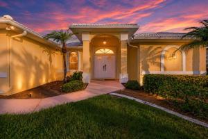 a house with a palm tree in front of a sunset at Gorgeous home with private pool & outdoor space dock in Cape Coral +31 photos
