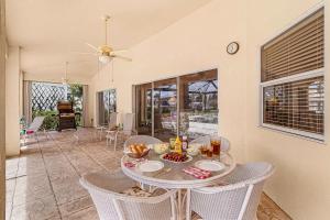 a dining room with a table and chairs at Gorgeous home with private pool & outdoor space dock in Cape Coral