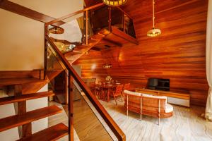 a living room with a staircase and a dining room at Pousada Recanto dos Chalés in Cruz