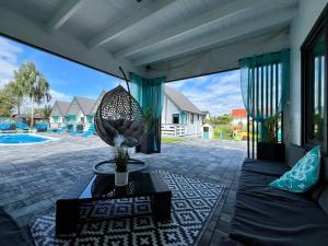 a patio with a table and a view of a pool at Domki Kompas in Jantar