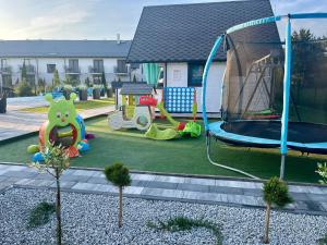 a backyard with a playground with a play equipment at Domki Kompas in Jantar