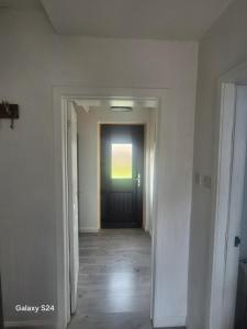 an empty hallway with a door in a house at Millers Ben Nevis View in Caol