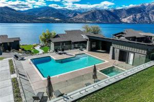 an aerial view of a house with a swimming pool at Designer Lakefront Condo E3 Wapato Point Chelan in Manson