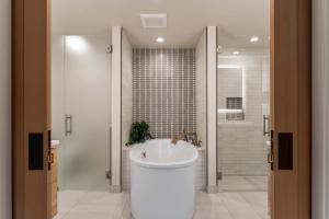a bathroom with a white tub and a shower at Designer Lakefront Condo E3 Wapato Point Chelan in Manson