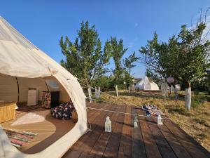 a tent on top of a wooden deck at Ofidaki Glamping in Vama Veche