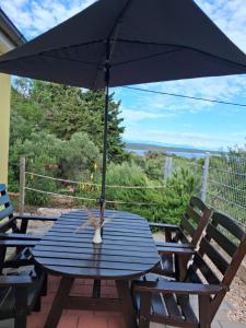a blue table with an umbrella on a patio at Vivi holiday house for 4 people in Nerezine