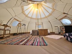 a large room with a large rug in a tent at Ofidaki Glamping in Vama Veche