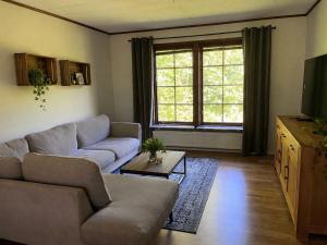 a living room with a couch and a table at Lilla lyckan in Skälsböke