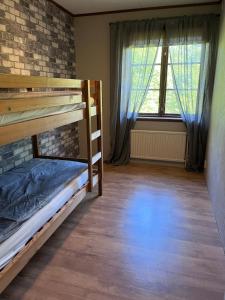 a room with two bunk beds and a large window at Lilla lyckan in Skälsböke