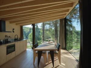 a kitchen and dining room with a table and a large window at Hutstuf Bertogne in Bertogne