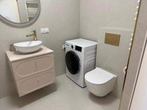 a bathroom with a washing machine and a sink at Apartament Baltic Pearl in Ustka