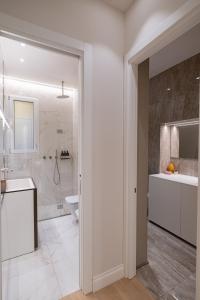 a bathroom with a toilet and a sink and a shower at Mamma Mia Holidays - Dimore Maggiori in Bologna +188 photos