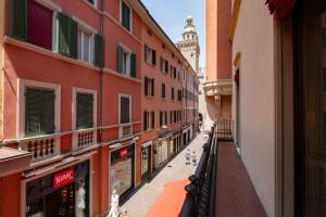 a city street with buildings and a clock tower at Mamma Mia Holidays - Dimore Maggiori in Bologna