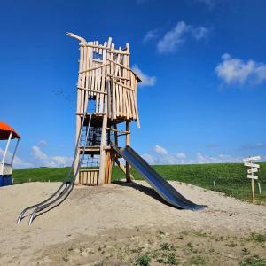 a playground in the sand with a slide at Thuis op Flakkee in Ooltgensplaat