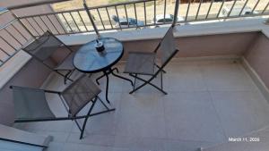 a balcony with a table and two chairs on it at Apartman E&A in Radanovići
