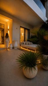 a woman walking through a room with two beds at Villa Almihauss - Adults Only in Afantou