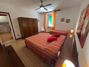a hotel room with two beds with red pillows at Appartamenti Via Roma 41 in Campo nell'Elba