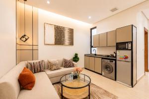 a living room with a couch and a glass table at السميح للشقق الذاتيه ALsUMAIH HOTELAPARTMENTS in Riyadh +35 photos
