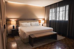 a bedroom with a large bed and a window at Maria Condesa Boutique in Mexico City
