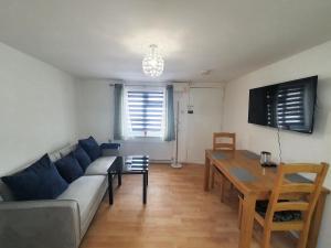 a living room with a couch and a table at Ground Floor Flat 1 Seven Cambrian square in Newtown