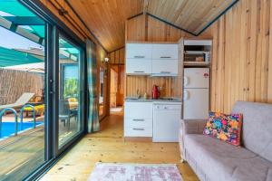 a kitchen and living room in a tiny house at Egem Tatil Evleri in Fethiye