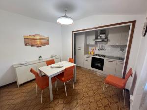a kitchen and dining room with a table and chairs at Appartamenti Via Roma 41 in Campo nell'Elba +28 photos