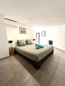 a bedroom with a large bed in a room at L'arbousier in Cassis