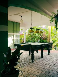 a pool table in the middle of a patio at Watermelon House at Nong Thale Garden & Kitchen in Ban Khao Klom