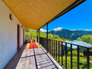 a balcony with a view of the mountains at Guesthouse Roza in Tsvirmi