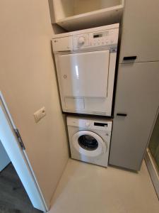 a washer and dryer in a small room at KEF QuickStay Apartments in Keflavík