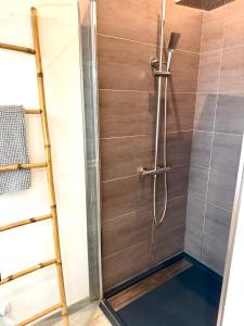 a shower with a glass door in a bathroom at L'arbousier in Cassis