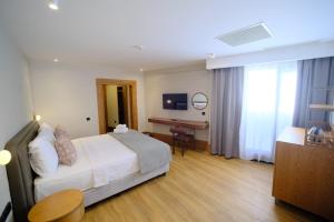 a hotel room with a bed and a desk at The Rizon Hotel in Antalya