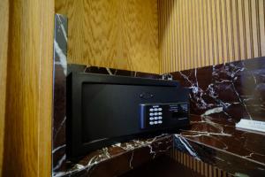 a microwave in a room with a marble wall at The Rizon Hotel in Antalya +52 photos