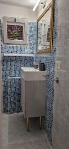 a bathroom with a sink and a mirror and a shower at Casa Marigé in San Nicola Arcella +7 photos