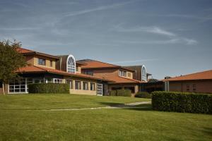 a large house with a lawn in front of it at Trinity Hotel og Konference, BW Signature Collection in Fredericia
