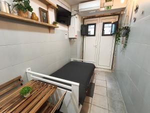 a small room with a bench and a door at Estúdio Madragoa in Lisbon