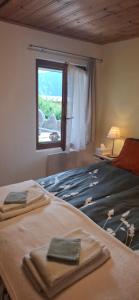 a bedroom with a bed with two towels on it at Chalet Clair de Lune bei Grächen VS in Gasenried